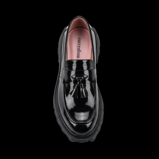 Top view of black high shine tassel loafer with pink lining and chunky sole