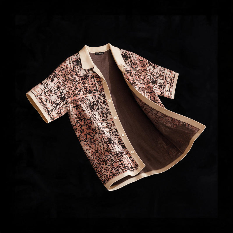 Short sleeve cotton knit camp collar shirt with a rust and cream tapestry jacquard pattern and cream ribbed placket