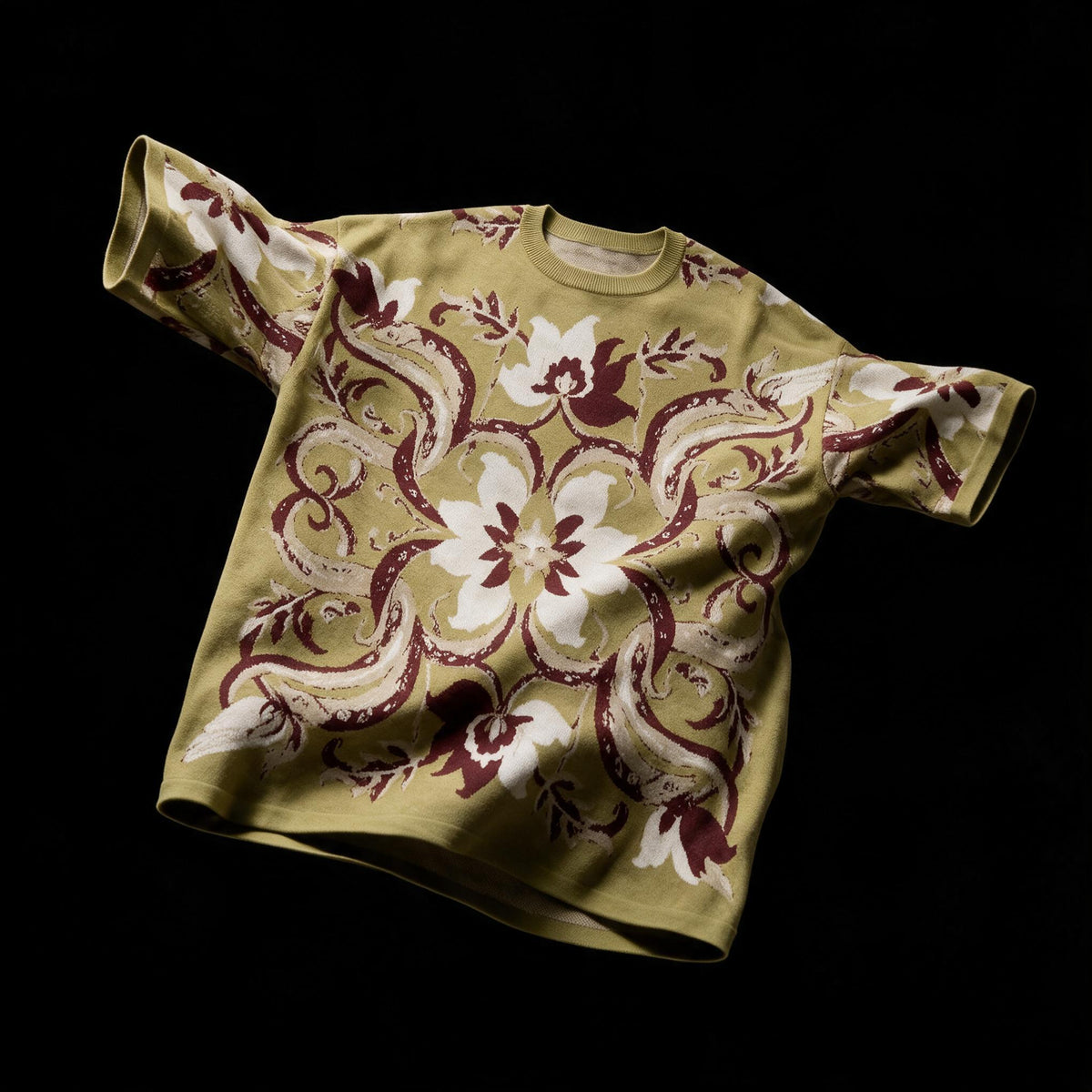Short sleeve olive green jacquard sweater with a bold mirrored floral pattern in burgundy and off white