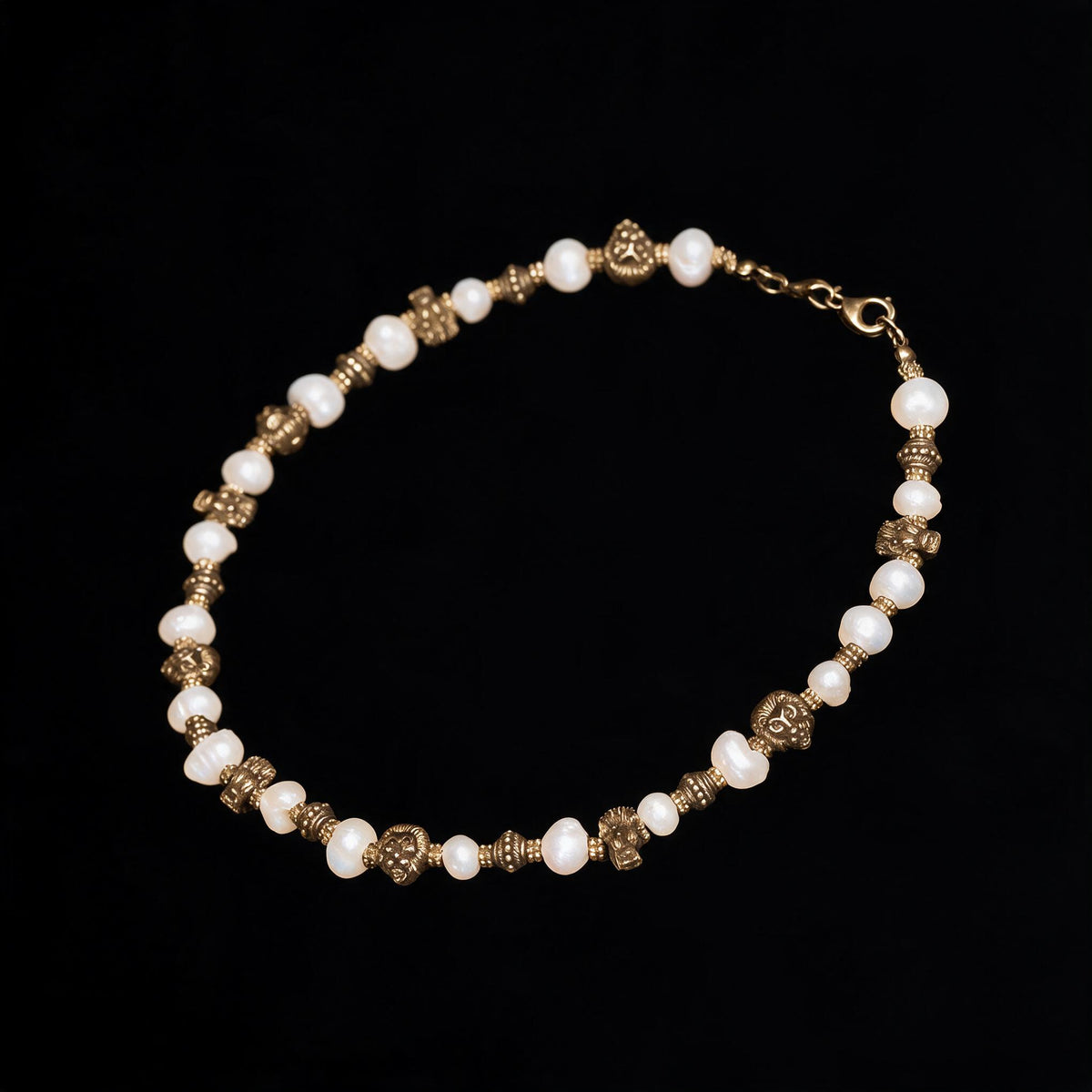 Beaded necklace of white pearls and antique brass lion and dragon heads on black