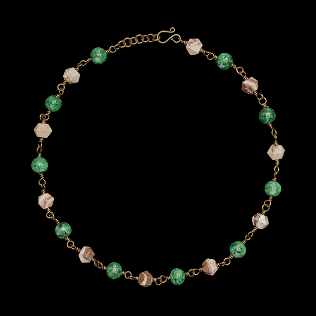 Beaded necklace with mottled green and faceted beige stone beads on a patinated chain