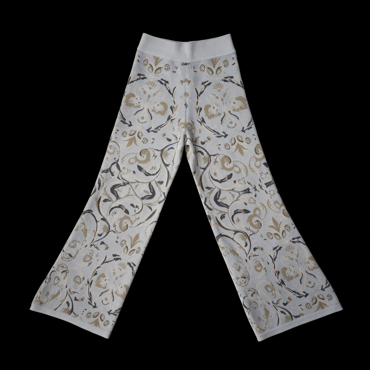Wide leg cotton jacquard knit trousers with a beige and charcoal floral scroll on a pale gray ground