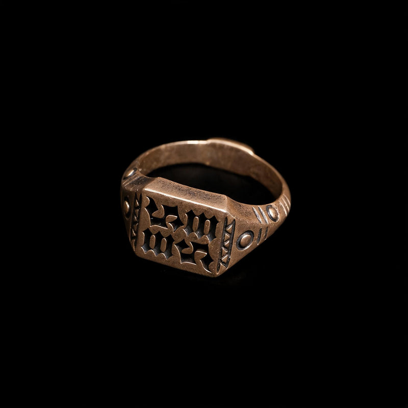 Warm brown tone otherworldly gothic signet ring with square openwork blackletter face and studded incised shoulders