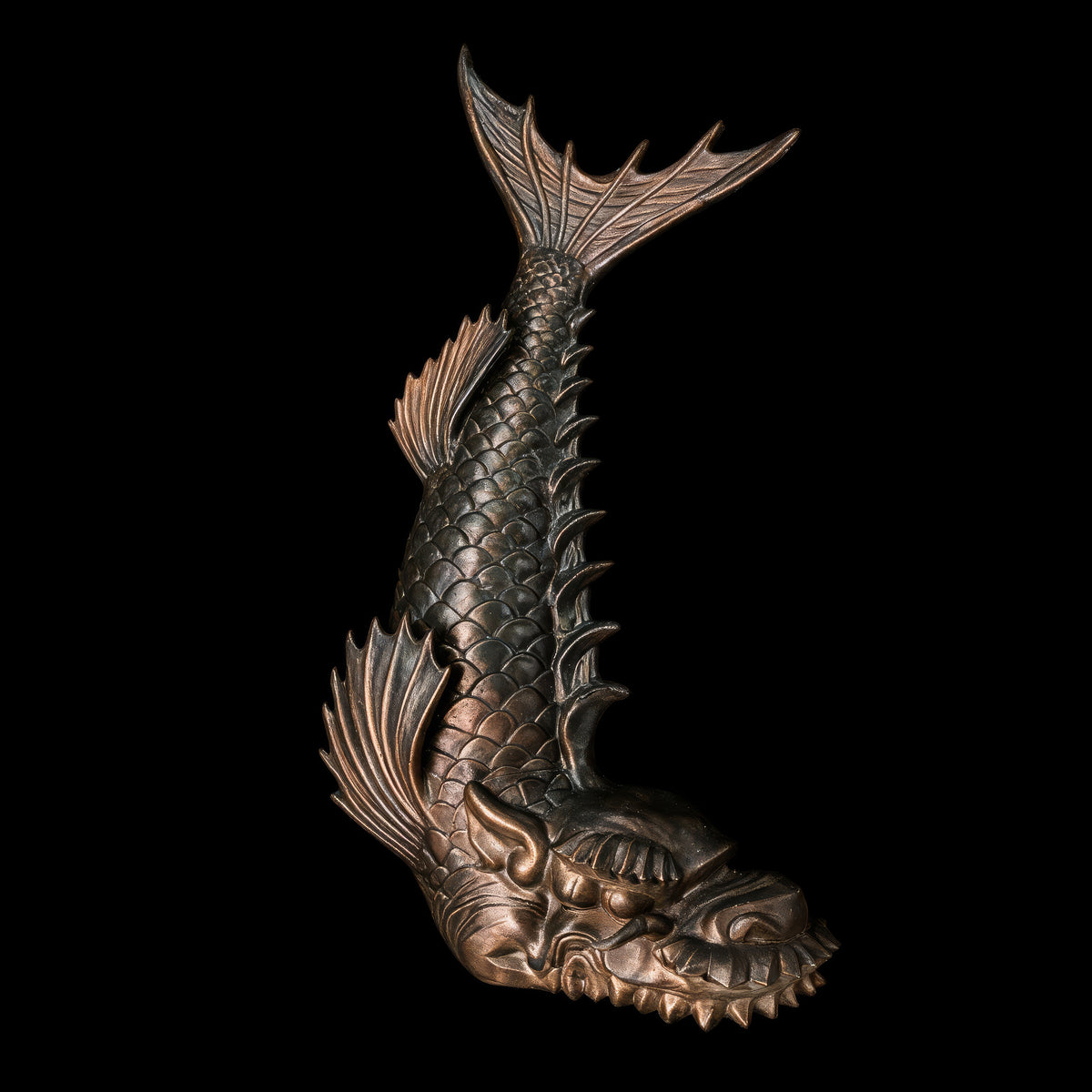 Dragon headed fish sculpture reared head down, scaled body with spined back and raised split tail