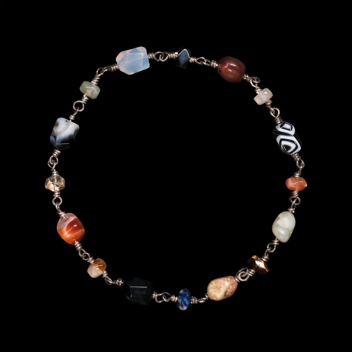 Beaded gemstone necklace of mixed natural stones spaced along a hand wired silver chain