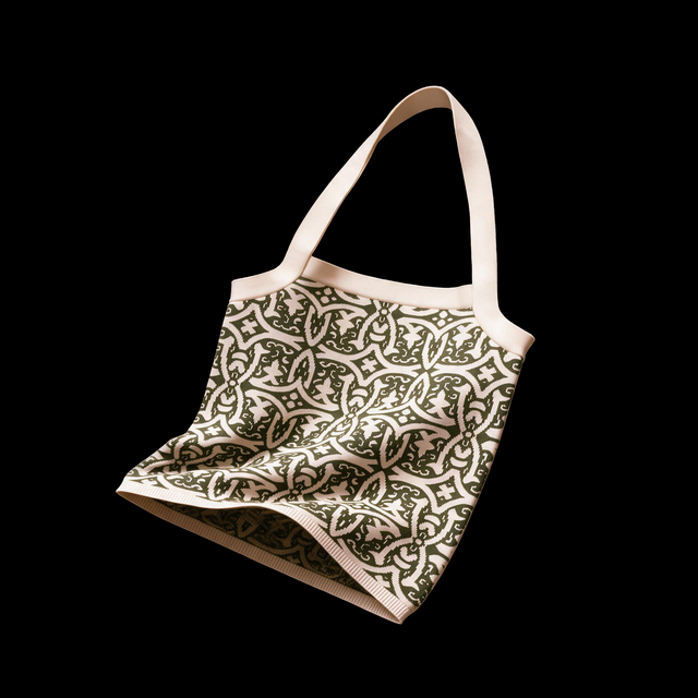 Soft knit tote bag in cream and forest green cotton jacquard with an otherworldly gothic ornamental pattern and long handle